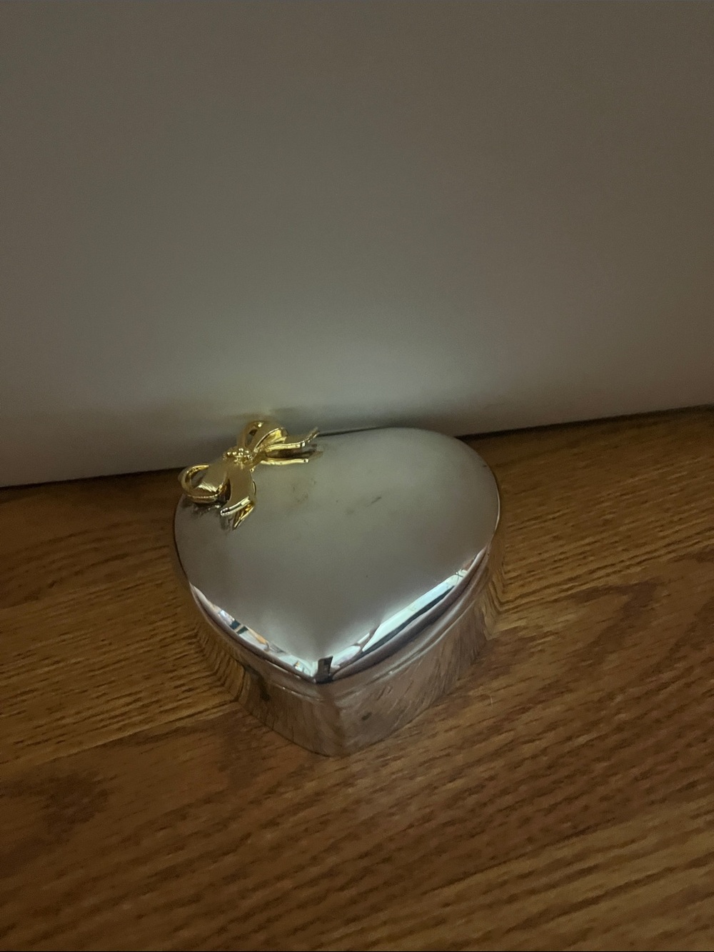 Heart-Shaped Silver Jewelry Box with Gold Bow Accent